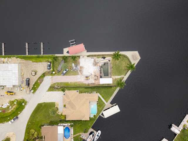 Wide cinematic aerial photograph of a demolition site